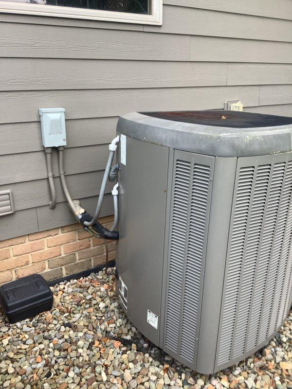 Completed HVAC estimate for full system replacement in a large residential property exceeding 3000 square feet. Assessed existing electric heat pump system with basement-located air handler for replacement with Lennox vertical upflow/downflow air handler unit and outdoor heat pump condenser. Evaluated current installation including indoor air handler with humidifier, electrical connections, copper refrigerant lines, and ductwork in utility room. Inspected outdoor condenser unit positioned on rock bed against exterior wall with proper electrical disconnect and PVC drainage lines. Documented existing system configuration and provided comprehensive replacement estimate for complete heating and cooling system upgrade.