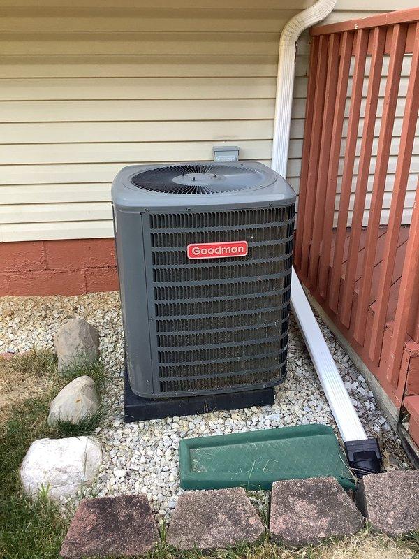 Performed comprehensive tune-up on 4-year-old Goodman air conditioning system, including inspection of indoor furnace unit and outdoor condenser. Removed and cleaned condenser screen, blew out debris from front of condenser unit, and cleaned condenser coil fins to ensure optimal airflow and heat transfer. Verified all system components are operating within normal parameters and confirmed proper drainage from condensate system.