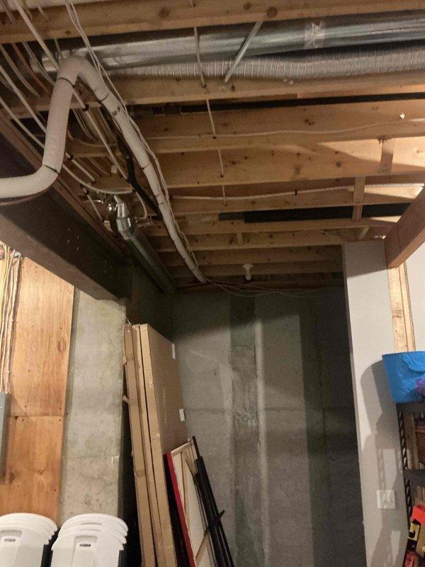 Conducted on-site assessment for whole home generator installation at residential property. Evaluated existing electrical infrastructure in basement area, documented current conditions including HVAC ductwork routing, structural framing, and available utility pathways for future generator integration. Photographed unfinished basement space to identify optimal placement for transfer switch installation and necessary electrical panel modifications to accommodate automatic standby generator system.