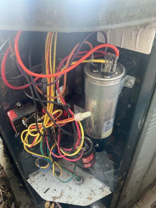 Completed MVP cooling maintenance visit on 11-year-old system. Performed comprehensive inspection of condensing unit, examining copper refrigerant lines showing normal age-related oxidation, verified capacitor condition and electrical connections, and assessed overall system operation. All components found functioning within normal parameters for unit age, with wiring and internal compartment showing typical wear consistent with years of service.