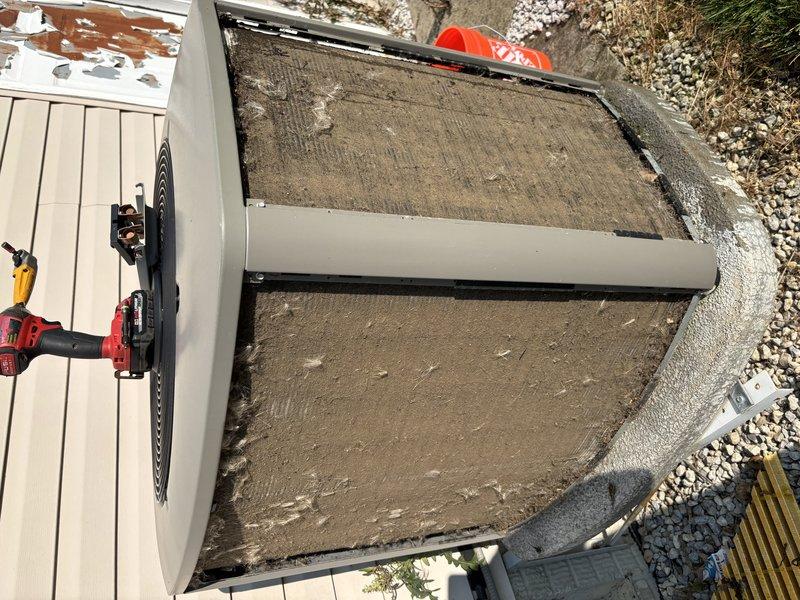 # HVAC Maintenance - Cooling

Completed preventive maintenance cooling visit on a 7-year-old heat pump system. Upon arrival, found extensive debris accumulation on condenser unit top surface and coil area, with thick buildup of dirt, dried leaves, and organic matter significantly obstructing airflow. Unit also exhibited substantial dust and fibrous material coating on underside components and internal surfaces, indicating extended period without cleaning.

Performed thorough inspection and cleaning of outdoor condenser unit. Removed heavy debris layer from top surface and coil sections to restore proper air circulation. Cleaned accumulated dust and contaminants from underside housing and internal components. Verified refrigerant line connections and condensate drain system during service. Assessed overall unit condition and confirmed system operational status following maintenance procedures.

System returned to proper working condition with improved airflow capacity. Documented equipm