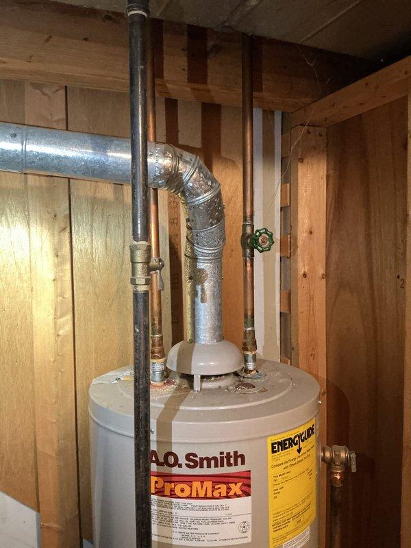Conducted on-site assessment and provided estimate for gas water heater replacement in residential property. Evaluated existing A.O. Smith ProMax gas water heater, approximately twenty years old, located in unfinished basement area with exposed framing. Documented current installation configuration including gas line connections, water supply piping with brass fittings and shutoff valves, vent pipe system, and drain connections. Assessed structural conditions of installation area, noting exposed wooden joists and adequate clearance for replacement unit. Photographed existing equipment and plumbing connections to provide accurate quote for new gas water heater installation, including removal and disposal of old unit and necessary code-compliant connections.