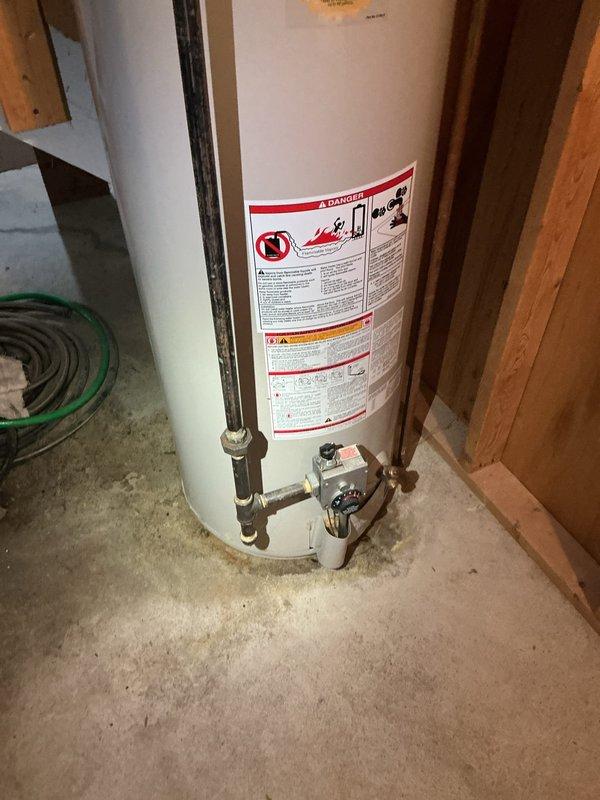 Conducted on-site assessment and provided estimate for gas water heater replacement in residential property. Evaluated existing A.O. Smith ProMax gas water heater, approximately twenty years old, located in unfinished basement area with exposed framing. Documented current installation configuration including gas line connections, water supply piping with brass fittings and shutoff valves, vent pipe system, and drain connections. Assessed structural conditions of installation area, noting exposed wooden joists and adequate clearance for replacement unit. Photographed existing equipment and plumbing connections to provide accurate quote for new gas water heater installation, including removal and disposal of old unit and necessary code-compliant connections.
