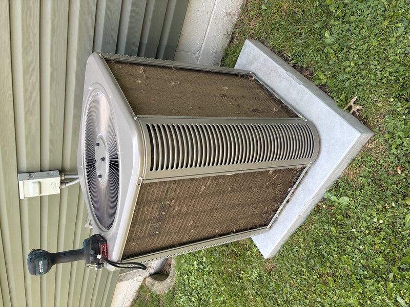 Completed MVP cooling maintenance visit on 3-year-old residential air conditioning system. Performed standard inspection of outdoor condenser unit, noting accumulated dirt and debris on cooling coils and fins. Cleaned condenser coils to restore optimal heat transfer efficiency and airflow capacity, addressing the visible brownish discoloration and buildup that can reduce system performance and increase operating costs. Unit operational and functioning properly upon completion of maintenance service.
