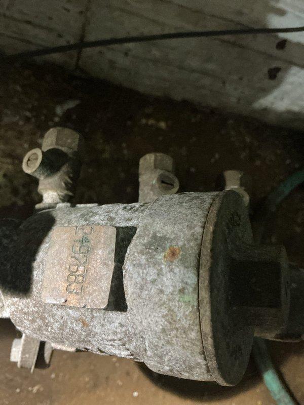 Completed annual backflow prevention device testing on a ninety-year-old residential property. Upon arrival, inspected the existing backflow assembly located in the basement area, which exhibited significant age-related corrosion, mineral deposits, and surface oxidation consistent with the home's age. Performed comprehensive testing procedures on the backflow preventer to verify proper operation and compliance with local plumbing codes. All test ports, check valves, and relief valve components were evaluated for functionality. The device passed testing requirements with acceptable pressure differentials and check valve sealing. Documented the assembly's condition with photographic records showing the corroded brass fittings, oxidized piping, and overall wear patterns typical of decades-old installations. No leaks, failures, or operational deficiencies were detected during testing procedures. The backflow prevention system is functioning as designed to protect the potable water supply f