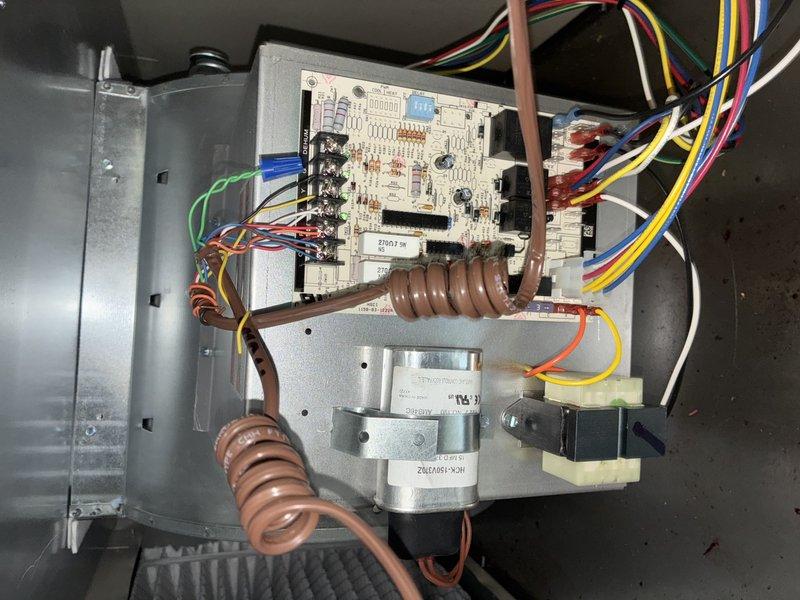Completed MVP recurring cooling maintenance visit on residential HVAC system. Performed comprehensive inspection of evaporator coil assembly, noting moderate dust and debris accumulation on aluminum fins consistent with normal operational wear. Inspected control board assembly, verified all electrical connections secure, and confirmed proper wire terminations at terminal block. Documented system condition through photographic records showing evaporator coil with visible dirt buildup, refrigerant line connections, and control board with heating elements properly installed and functioning.