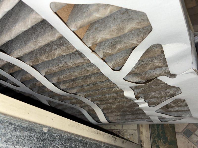Responded to complaint of excessive noise and inadequate cooling on second floor following recent PCB installation. Upon inspection, discovered heavily contaminated return air filters with significant dust and debris accumulation, restricting airflow to the system. Verified system operation using digital multimeter to check electrical parameters and confirm proper component function. Identified clogged filters as primary cause of reduced cooling capacity and increased operational noise due to restricted airflow forcing system to work harder. Documented conditions with photos showing extent of filter contamination and diagnostic testing performed.