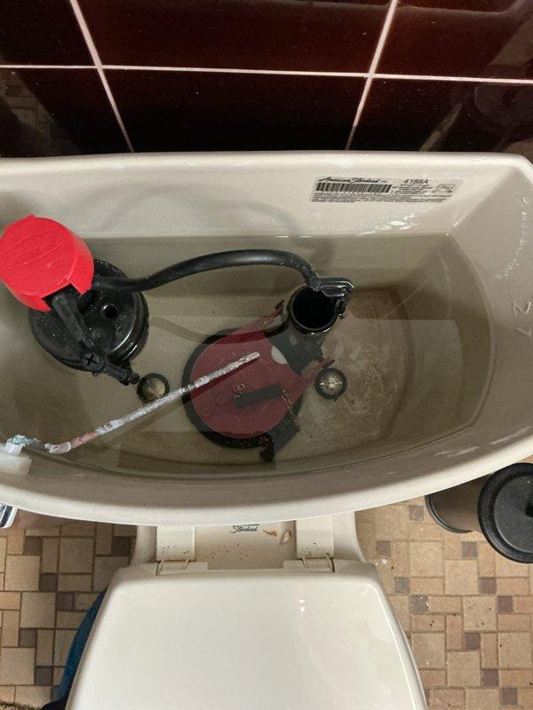 Responded to emergency service call for non-functioning toilet. Upon inspection, found defective internal flush mechanism components including worn flapper valve and faulty flush valve assembly. Removed toilet tank lid, assessed condition of all internal components, and documented existing mineral deposits and component wear. Repaired toilet by replacing malfunctioning internal parts, restoring proper flushing operation and resolving the emergency issue.
