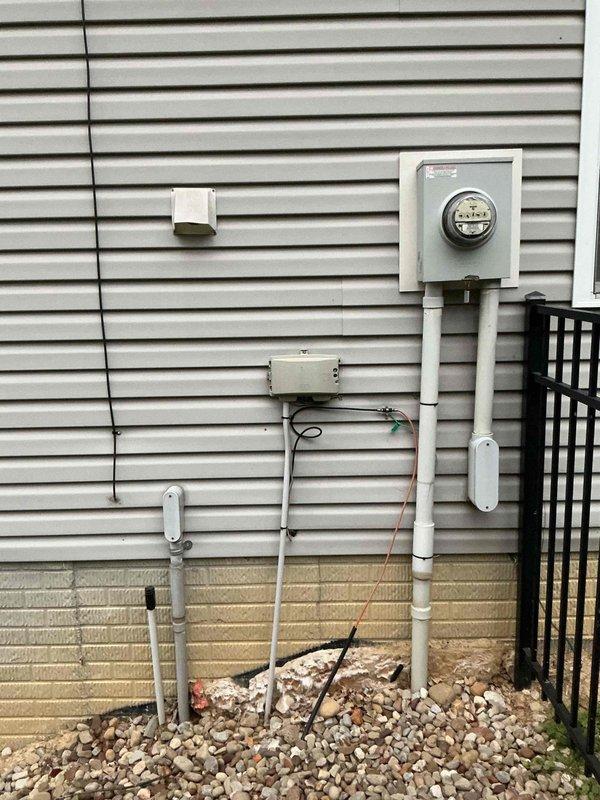 Completed comprehensive electrical estimate for whole home generator installation at residential property. Assessed existing electrical service panel, meter location, and optimal generator placement on concrete patio area adjacent to house foundation. Documented current electrical infrastructure including meter box, junction boxes, and conduit routing along exterior wall to determine connection requirements and necessary materials for generator integration into home electrical system.