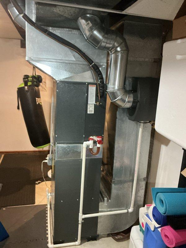 Completed full HVAC system installation including outdoor condensing unit and indoor evaporator coil. Installed new air conditioning unit on concrete pad in backyard with proper refrigerant line routing to exterior wall, mounted electrical disconnect box on siding, and established all necessary connections. Interior installation included integration of new evaporator coil with existing furnace system and complete ductwork configuration to ensure proper airflow throughout the residence.