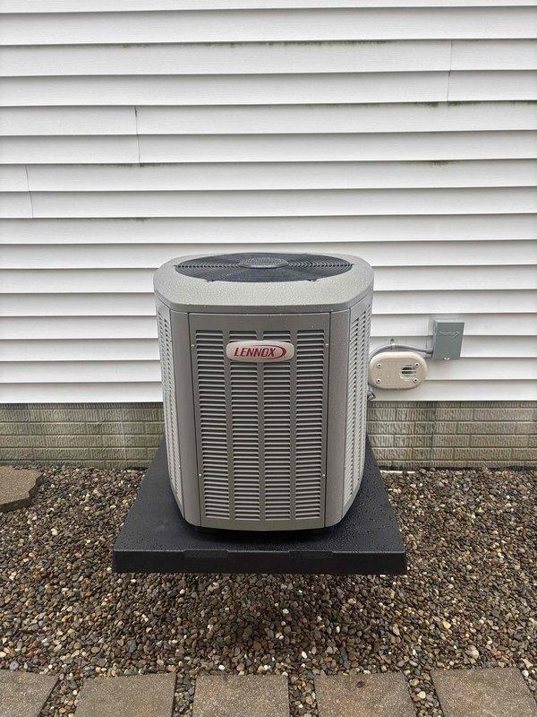 Completed installation of new Lennox air conditioning system including indoor evaporator coil and outdoor condensing unit. Installed indoor coil assembly integrated with existing Lennox furnace in basement mechanical room, with proper refrigerant line sets routed alongside PVC condensate drainage and venting system. Mounted outdoor Lennox condenser unit on equipment pad with gravel base against exterior wall, installed electrical disconnect box, and established all necessary electrical connections. Verified proper refrigerant charge, tested system operation, and confirmed all components functioning within manufacturer specifications.