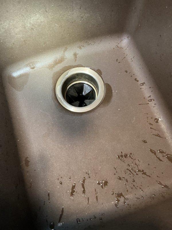 Completed garbage disposal installation in kitchen of 1952-built residential home. Removed existing drain assembly and mounted customer-supplied disposal unit beneath stainless steel sink basin. Connected discharge piping to existing plumbing system and verified electrical connection to wall-mounted switch. Tested unit for proper operation, drainage, and leaks. Disposal is now fully functional with no leaks detected.
