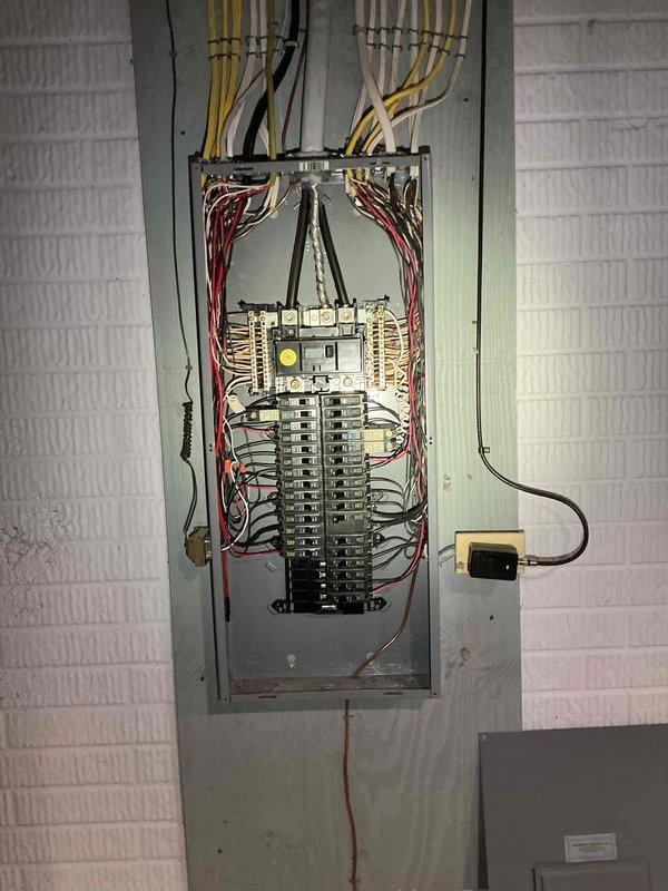 Conducted electrical estimate for generator installation at residential property. Evaluated existing electrical panel configuration and available space in unfinished basement utility area for generator integration. Documented current electrical service capacity, panel layout with multiple circuit breakers, and incoming service wiring to determine compatibility with proposed generator system and transfer switch requirements.