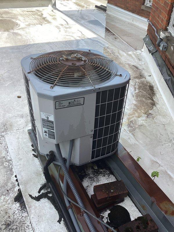 Responded to service call for two attic-mounted A/C units with one non-operational system. Upon inspection, discovered outdoor condenser unit with heavily corroded fan guard and accumulated debris including foam insulation material obstructing proper airflow. Cleared debris from fan assembly, inspected refrigerant lines and electrical connections, and verified both systems returned to normal operation.