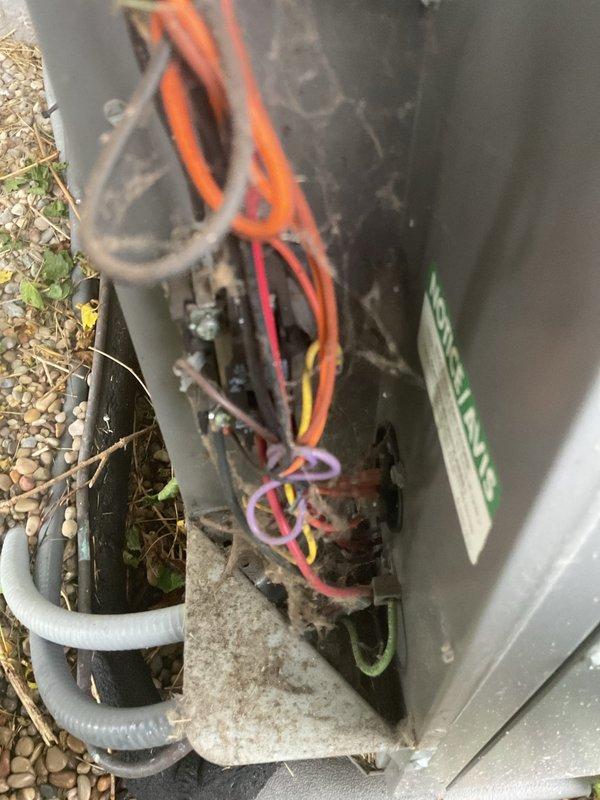 Responded to service call for 16-year-old central air conditioning system experiencing inadequate cooling, weak airflow from vents, and random cycling without reaching setpoint temperature. Upon inspection, found outdoor condensing unit with significant dirt and debris accumulation affecting performance. Cleaned and serviced electrical connections showing weathering and exposure damage, removed debris from unit base and interior components, and verified proper electrical function of contactor and wiring. Addressed airflow restrictions and cyclic operation issues through system diagnostics and component cleaning. Unit tested successfully after service with improved cooling capacity and normal cycling operation restored.