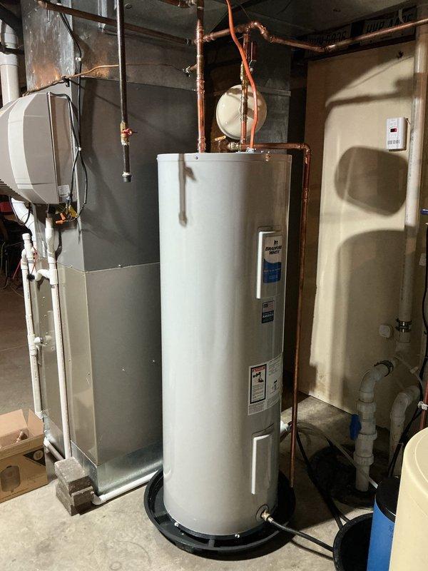 Replaced existing 50-gallon electric water heater with new Bradford White 50-gallon electric unit in basement utility area. Installation included new shut-off valve, expansion tank, and proper copper piping connections to hot and cold water lines. Pressure relief valve discharge piping was installed per code requirements. Unit is backed by 6-year manufacturer warranty and all connections were tested for proper operation upon completion.