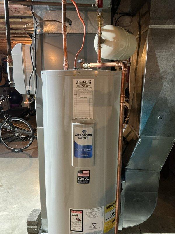 Replaced existing 50-gallon electric water heater with new Bradford White 50-gallon electric unit in basement utility area. Installation included new shut-off valve, expansion tank, and proper copper piping connections to hot and cold water lines. Pressure relief valve discharge piping was installed per code requirements. Unit is backed by 6-year manufacturer warranty and all connections were tested for proper operation upon completion.