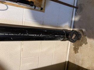 Responded to service call for water leak from tankless water heater piping and reported chemical odor in crawl space. Inspected recent copper piping and exhaust pipe rerouting installation. Documented deteriorated penetration points where black flexible exhaust ducting passes through wall surfaces, noting significant material degradation, brown staining, and compromised sealing around pipe penetrations that could allow moisture intrusion and potential fume migration into living space.