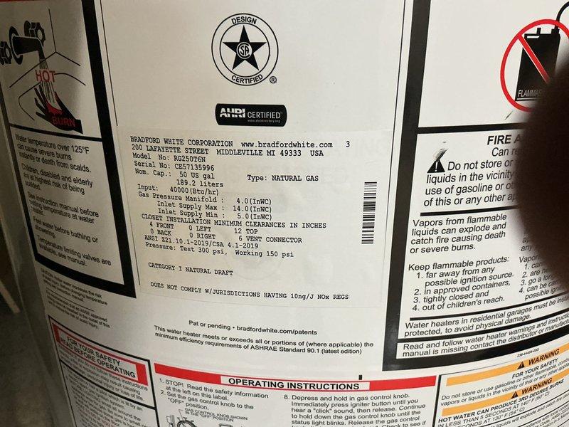 Completed installation of 50-gallon Bradford White natural gas water heater with ball valve and expansion tank, converting from existing tankless system. Repiped gas and water lines with copper connections, discontinued electrical service with proper junction box installation in ceiling, and sealed flue pipe at chimney connection. All safety labels and specifications verified, unit tested and operational per manufacturer requirements.