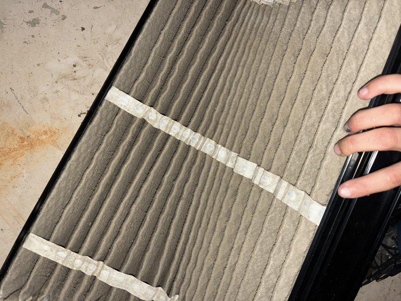 Responded to no cooling complaint on second floor of residence with 1-year-old HVAC system. Upon arrival, found thermostat set to 74°F and inspected air filter, which showed moderate dust accumulation and debris buildup. Replaced dirty air filter to restore proper airflow and system efficiency, resolving the cooling issue on the upper level.