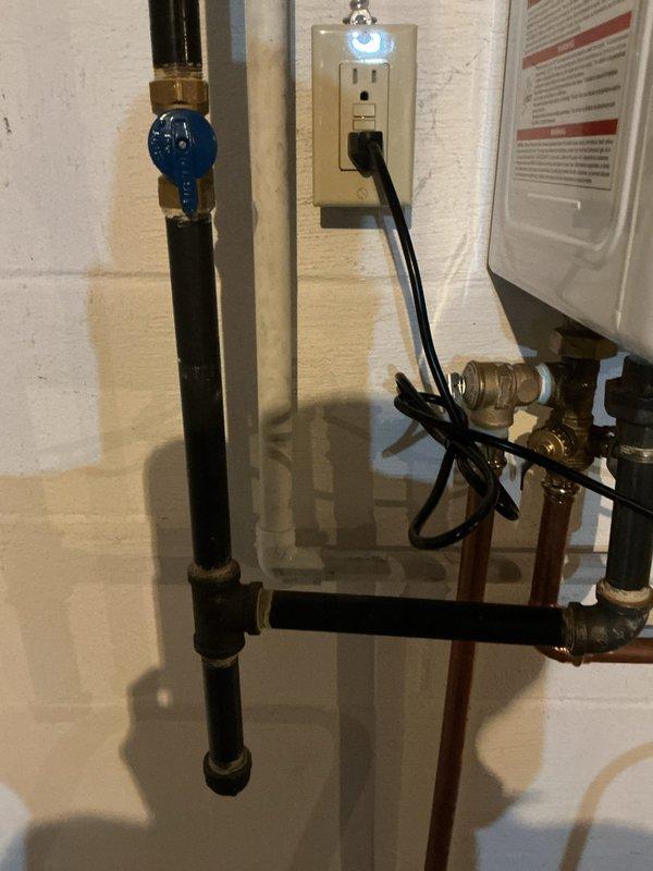 Responded to error code 003 on Navien NPE 240 A2 tankless water heater. After consulting with technical support, diagnosed failed heat exchanger and dual Venturi requiring replacement under manufacturer warranty. Replaced both heat exchanger and dual Venturi components per manufacturer specifications. Modified exhaust venting system by snorkeling 16 inches upward using two PVC 90-degree elbows to improve exhaust discharge. Installed wye fitting on fresh air intake line to provide moisture drainage capability before entering unit. Cut into fresh air intake piping in basement, installed wye fitting, and tied discharge line into existing 3/4-inch condensate drain system. Coordinated parts ordering with warranty-covered components shipped directly from manufacturer and additional required materials sourced separately. Staged all components together prior to installation to ensure complete repair. System tested and verified operational upon completion with error code cleared.
