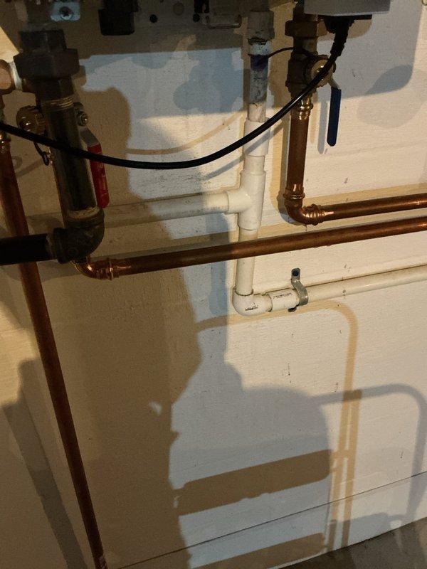 Responded to error code 003 on Navien NPE 240 A2 tankless water heater. After consulting with technical support, diagnosed failed heat exchanger and dual Venturi requiring replacement under manufacturer warranty. Replaced both heat exchanger and dual Venturi components per manufacturer specifications. Modified exhaust venting system by snorkeling 16 inches upward using two PVC 90-degree elbows to improve exhaust discharge. Installed wye fitting on fresh air intake line to provide moisture drainage capability before entering unit. Cut into fresh air intake piping in basement, installed wye fitting, and tied discharge line into existing 3/4-inch condensate drain system. Coordinated parts ordering with warranty-covered components shipped directly from manufacturer and additional required materials sourced separately. Staged all components together prior to installation to ensure complete repair. System tested and verified operational upon completion with error code cleared.