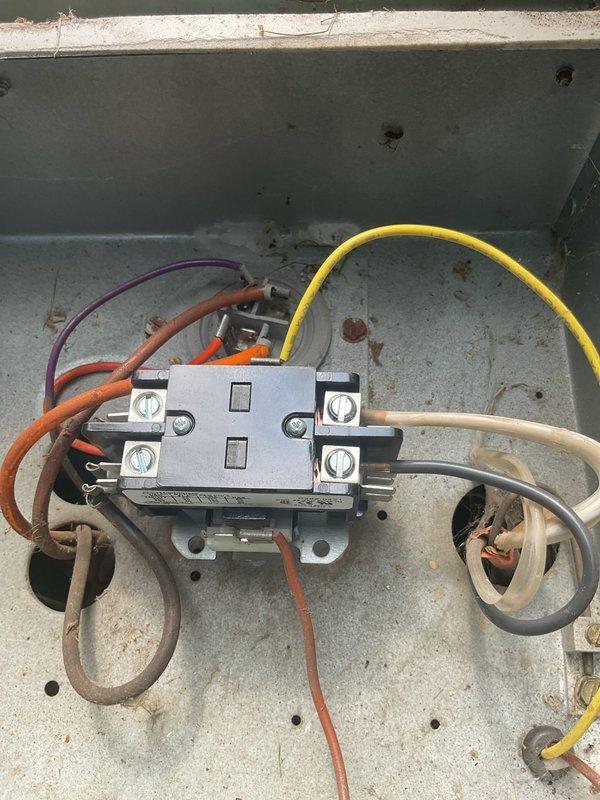# A/C Service Call - No Power to Unit

Responded to service call for 20-year-old air conditioning system that would not start. Upon arrival, performed visual inspection of outdoor condenser unit and electrical components. Located electrical contactor inside control panel showing signs of significant wear and deterioration. Found aged wiring connections with discoloration and debris accumulation within electrical enclosure. Diagnosed failed contactor as primary cause preventing compressor and condenser fan from engaging. Replaced defective contactor with new unit, ensuring proper wire terminations and secure connections. Cleaned electrical enclosure of debris and verified all connections were tight. Tested system operation and confirmed successful startup of compressor and condenser fan. Unit now operating within normal parameters.