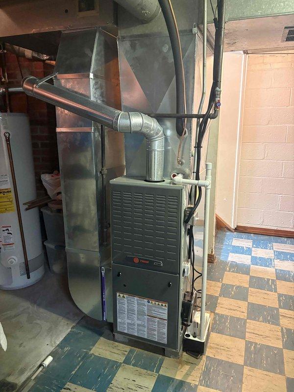 Completed second-phase installation of residential split-system air conditioning unit with matching evaporator coil. Installed Lennox outdoor condensing unit on vibration-dampening pad with proper clearances, connected refrigerant lines to indoor evaporator coil mounted above existing Trane furnace, established electrical connections to exterior disconnect and meter, and verified system operation with proper refrigerant charge and airflow.