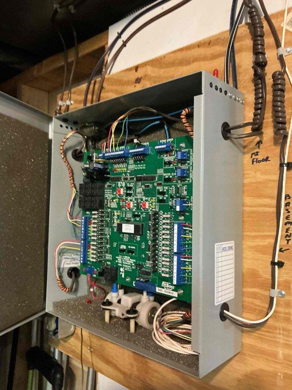 Responded to no cooling complaint with multiple thermostats inoperative. Inspected zone control panel and circuit boards, finding previous battery terminal corrosion issue had recurred affecting system power distribution. Cleaned all thermostat battery terminals, verified proper voltage at zone control board, and restored functionality to all three zone thermostats. System tested successfully with all zones operating normally and recommended thermostat replacement due to age and recurring corrosion issues to prevent future failures.