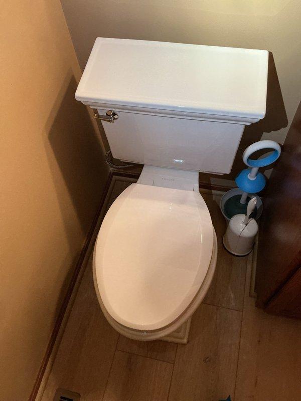 Installed a new Kohler Memoirs Stately square bottom toilet with 16.5" comfort height and elongated bowl in the first floor bathroom. Reconnected the washing machine using new braided metal hoses and restored the icemaker line connection to the refrigerator, ensuring all water supply lines were properly secured and leak-free.