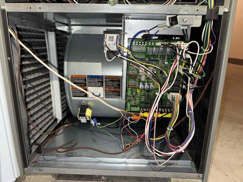 Completed MVP cooling maintenance visit on 8-year-old system. Performed comprehensive inspection of outdoor condensing unit and indoor air handler components. Checked refrigerant levels, electrical connections, and control board operation. Inspected blower assembly and verified proper airflow. Examined exterior utility penetrations through brick wall, noting multiple PVC lines, electrical conduit, and proper sealing around penetration points. Replaced thermostat batteries per customer request and provided instruction on future battery replacement procedure. All system components operating within normal parameters. Unit tested and left in proper working condition.