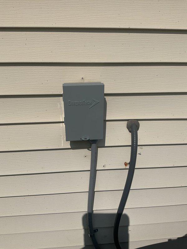 Responded to service call for loud noise complaint on 2-year-old Lennox air conditioning unit. Upon arrival, performed complete system inspection of outdoor condensing unit and electrical disconnect. Conducted operational test and noise diagnostic to identify source of abnormal sound. Inspected condenser fan motor, fan blades, and compressor for mechanical issues. Checked all mounting hardware, refrigerant line supports, and unit leveling on pad. Verified electrical connections at disconnect box and unit. System photographed and documented showing unit properly installed on composite pad with secure wall-mounted disconnect. All components found in good operating condition with no visible damage or wear concerns noted during inspection.