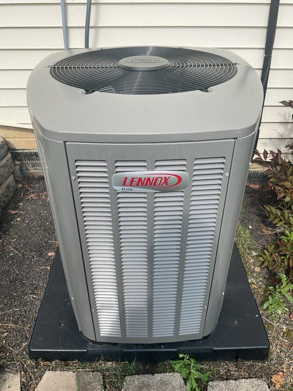 Responded to service call for loud noise complaint on 2-year-old Lennox air conditioning unit. Upon arrival, performed complete system inspection of outdoor condensing unit and electrical disconnect. Conducted operational test and noise diagnostic to identify source of abnormal sound. Inspected condenser fan motor, fan blades, and compressor for mechanical issues. Checked all mounting hardware, refrigerant line supports, and unit leveling on pad. Verified electrical connections at disconnect box and unit. System photographed and documented showing unit properly installed on composite pad with secure wall-mounted disconnect. All components found in good operating condition with no visible damage or wear concerns noted during inspection.
