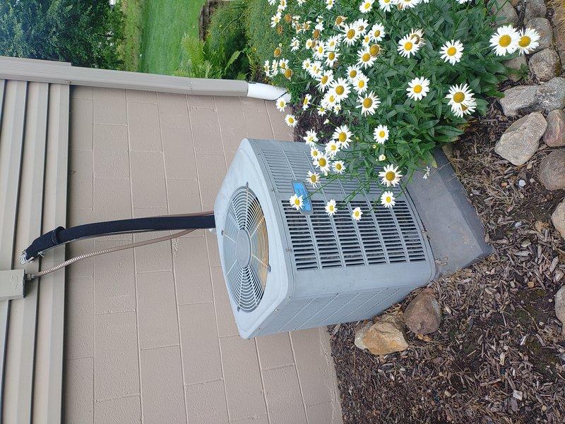 Completed comprehensive air conditioning tune-up on residential outdoor condenser unit. Performed standard preventive maintenance procedures including inspection of electrical components, verified proper fuse operation, checked refrigerant lines for leaks and proper insulation, cleaned condenser coils, and tested system performance. All components found to be in good working condition with no immediate repairs required.