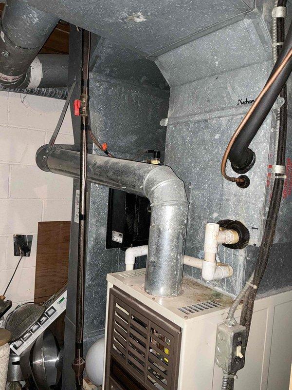 Responded to insurance claim for flooded furnace and air conditioning system due to backup water damage. Assessed exterior AC condenser unit and interior furnace/air handler in mechanical room, documenting extensive water damage to HVAC equipment for replacement estimate. Photographed all affected components including outdoor condensing unit, indoor furnace with exhaust venting, and surrounding mechanical infrastructure to support insurance documentation and system replacement requirements.