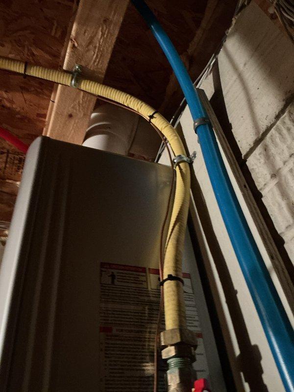 Removed existing Rinnai RL75 tankless water heater and replaced with new Rinnai RE180 unit in unfinished basement mechanical room. Installation included connecting copper hot and cold water supply lines with shutoff valves, installing PVC exhaust venting system, and completing all necessary electrical connections. Verified proper operation of new tankless water heater upon completion, ensuring adequate water flow and temperature control functionality.