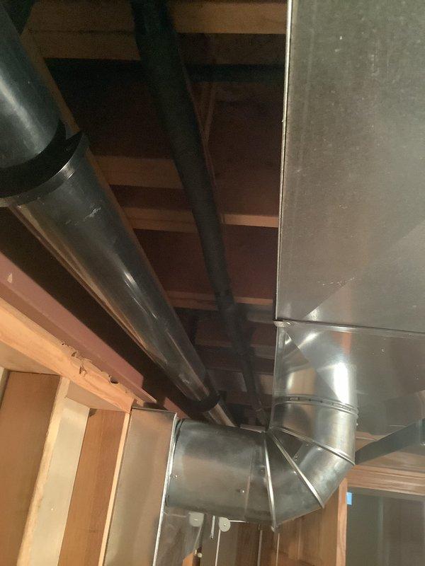 Conducted comprehensive on-site evaluation for furnace and air conditioning system replacement in residential property with unfinished basement installation area. Assessed existing HVAC infrastructure including ductwork configuration, supply and return air pathways, and mechanical space accessibility. Documented current system layout featuring flexible and rigid ductwork runs, evaluated structural clearances along exposed ceiling joists, and identified optimal equipment placement locations. Photographed existing installation conditions to support equipment sizing recommendations and replacement proposal development.