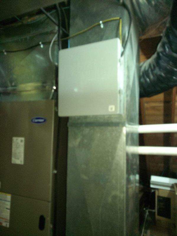 Completed installation of a two-trunk damper zone system for a Carrier HVAC unit. Installed zoning components including trunk dampers and associated ductwork in attic space, with system controls integrated to the existing furnace and air handler setup in the basement mechanical room.