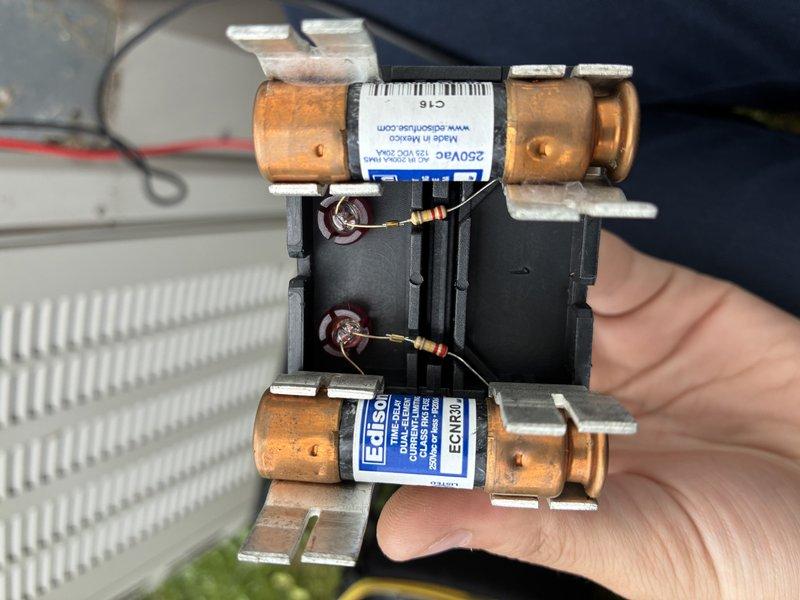 Completed preventive maintenance inspection on air conditioning system. Inspected and documented evaporator coil condition, which appeared clean with proper airflow through fins. Examined electrical components including dual fuse assembly with resistors and verified proper connections at refrigerant line entry points.