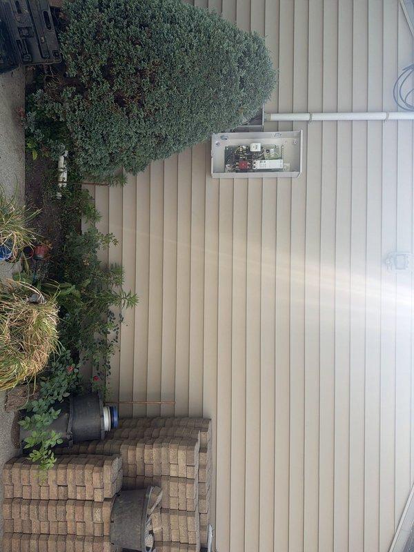 Completed installation of Generac 18kW standby generator with 200-amp automatic transfer switch and 45 feet of gas line supply connected to existing utility service. Performed electrical circuit modifications including junction work and wire removal at former electric tankless water heater location. Coordinated staging of generator equipment, transfer switch components, and oil heater unit prior to installation, with no utility disconnect required for the project.