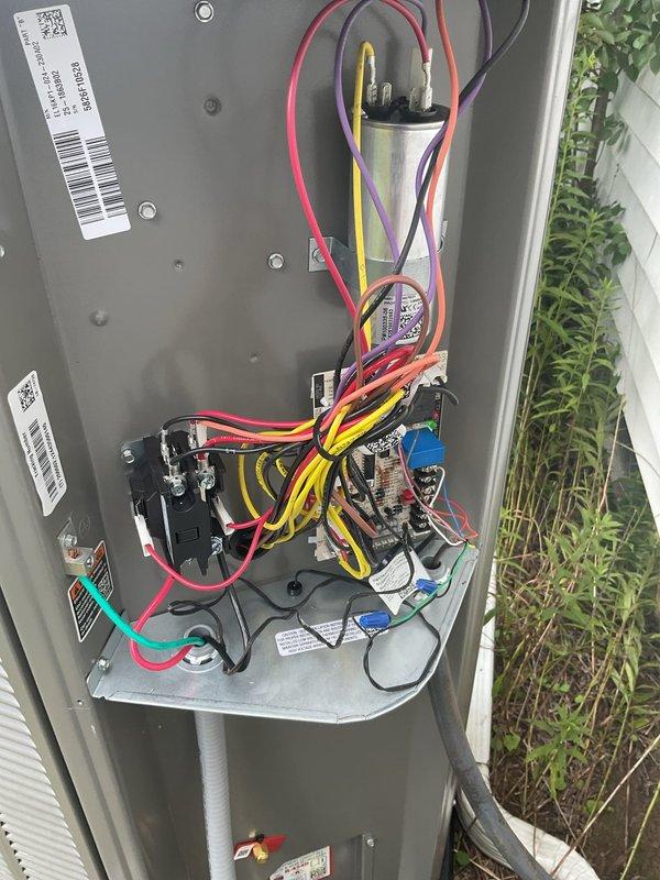 Responded to service call for outdoor thermometer sensor failure on recently installed heat pump system. Upon arrival, inspected electrical compartment and exterior components, verifying sensor connections and placement. Sensor probe was found hanging from unit with proper wire routing visible. Documented equipment condition including capacitor, contactors, control board, and all electrical connections within compartment. Confirmed sensor installation and wiring configuration, photographed components for warranty documentation purposes.