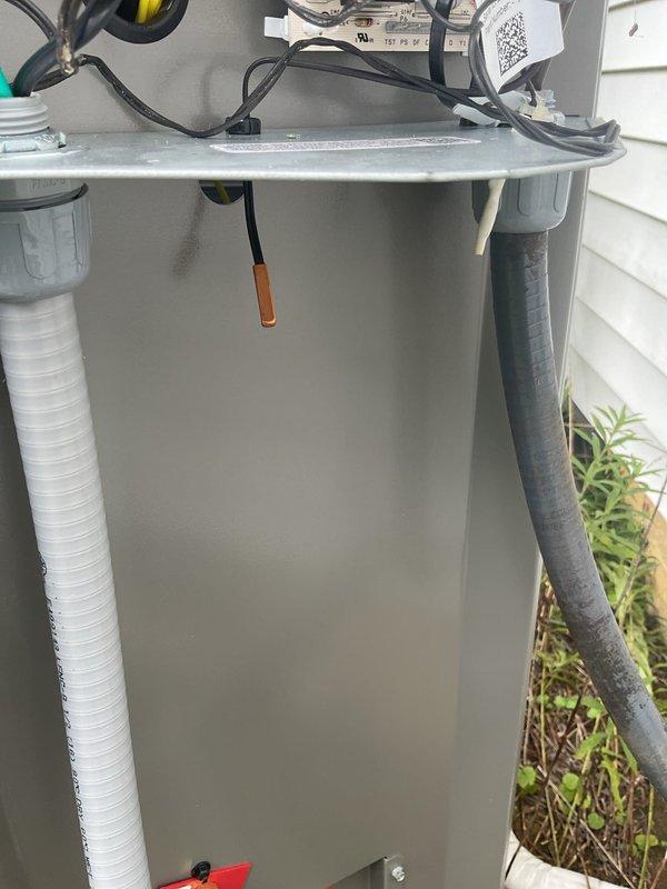 Responded to service call for outdoor thermometer sensor failure on recently installed heat pump system. Upon arrival, inspected electrical compartment and exterior components, verifying sensor connections and placement. Sensor probe was found hanging from unit with proper wire routing visible. Documented equipment condition including capacitor, contactors, control board, and all electrical connections within compartment. Confirmed sensor installation and wiring configuration, photographed components for warranty documentation purposes.