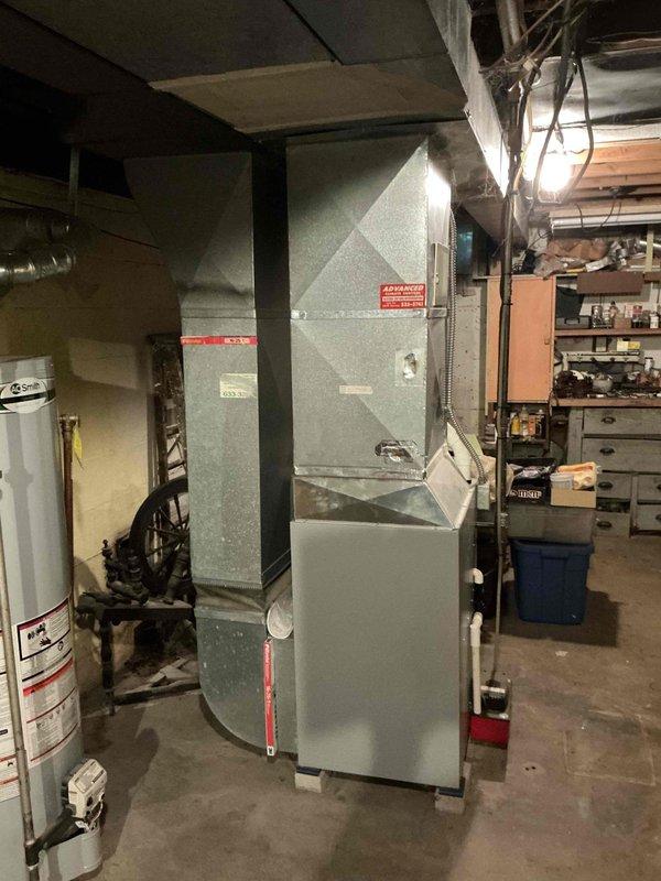 Conducted on-site evaluation for central air conditioning installation in small 3-bedroom residential property with existing Allied furnace and ductwork system. Assessed basement mechanical room containing recently installed furnace unit with proper PVC intake/exhaust venting, verified existing duct infrastructure compatibility, and documented current HVAC configuration including condensate pump and drainage components to provide comprehensive system replacement estimate.