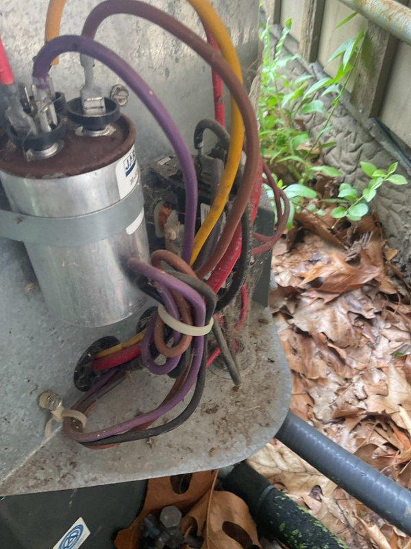 Responded to no cooling complaint on 13-year-old outdoor A/C unit where condenser fan was running but system not cooling. Diagnosed failed contactor preventing compressor operation. Replaced defective contactor with new unit, restored power to compressor, and verified proper system operation with all components functioning correctly.
