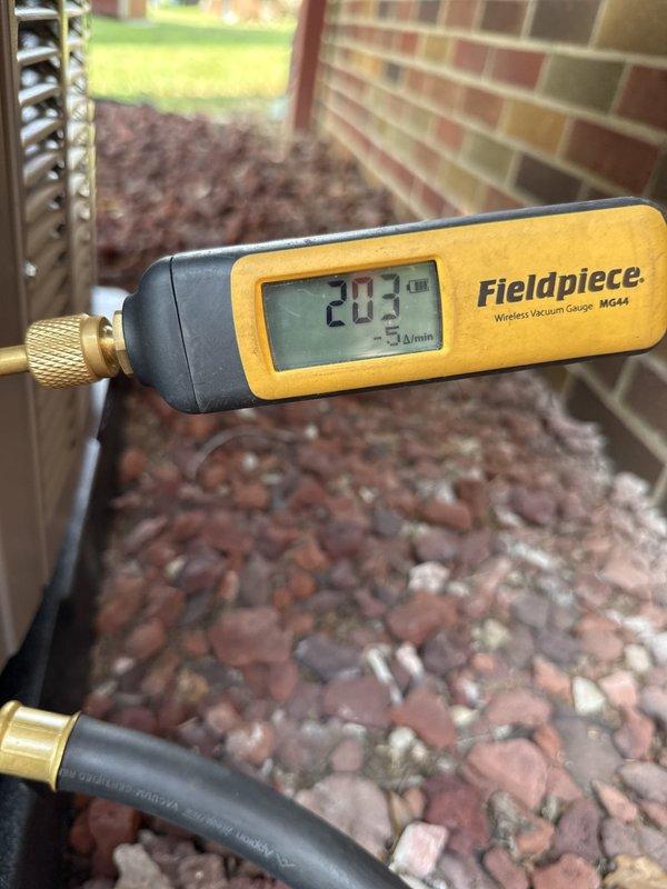 Completed full HVAC system installation including new air handler, air conditioning condenser unit, and complete ductwork replacement over two-day period. Installed new disconnect assembly with 25-amp Bussman fuses at outdoor unit location, performed system evacuation and verified proper vacuum levels reaching 203 microns using calibrated digital gauge to ensure system integrity before refrigerant charging. All components tested and operational upon completion.