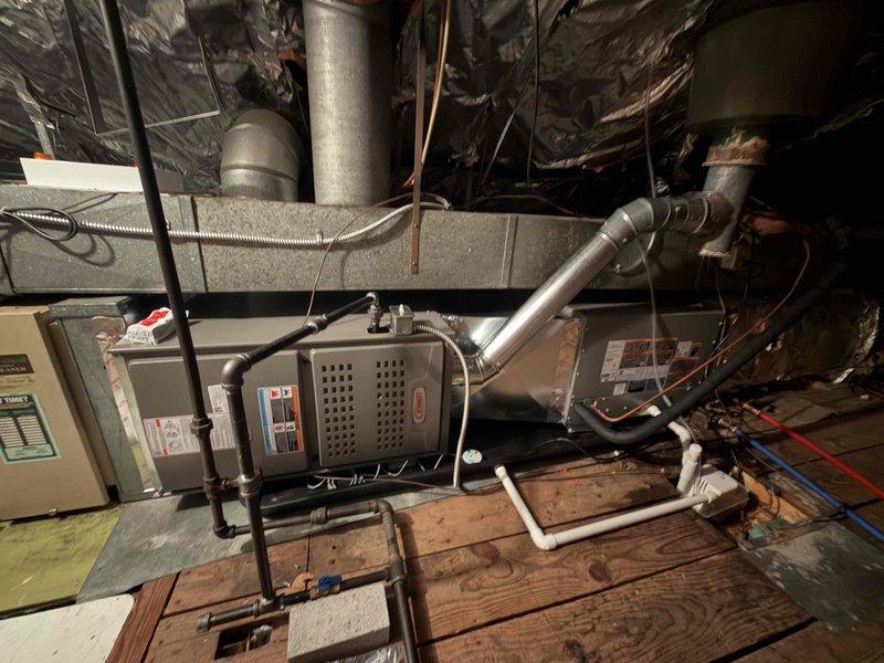 Completed installation of 80% efficiency furnace and air conditioning system in attic location. Installed new furnace unit with proper venting and exhaust piping, connected gas lines with appropriate securing, and integrated air handler with metallic supply ductwork. Installed outdoor condensing unit with proper electrical connections including 25-amp fused disconnect, ran refrigerant lines between indoor and outdoor equipment, and verified all electrical wiring and safety controls are functioning correctly per manufacturer specifications.