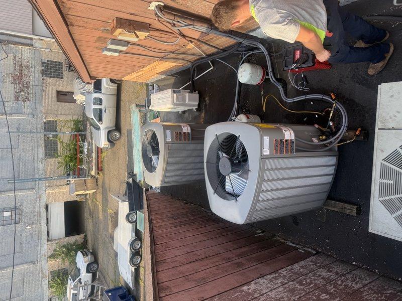 Completed commercial HVAC installation with two rooftop condenser units and corresponding evaporator coils positioned in the attic space. All electrical connections, refrigerant lines, and condensate drainage were properly installed and tested to ensure system functionality and compliance with manufacturer specifications.