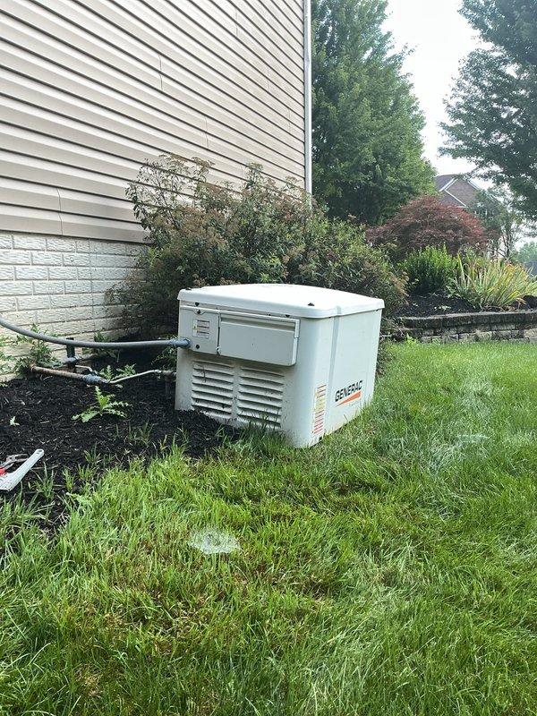 Releveled Generac PowerPact backup generator unit that had settled unevenly on its concrete pad. Transported decorative gravel from shop to site and installed gravel base beneath and around generator to ensure proper leveling and drainage. Verified unit was stable and level after adjustment to prevent operational issues and maintain manufacturer specifications.