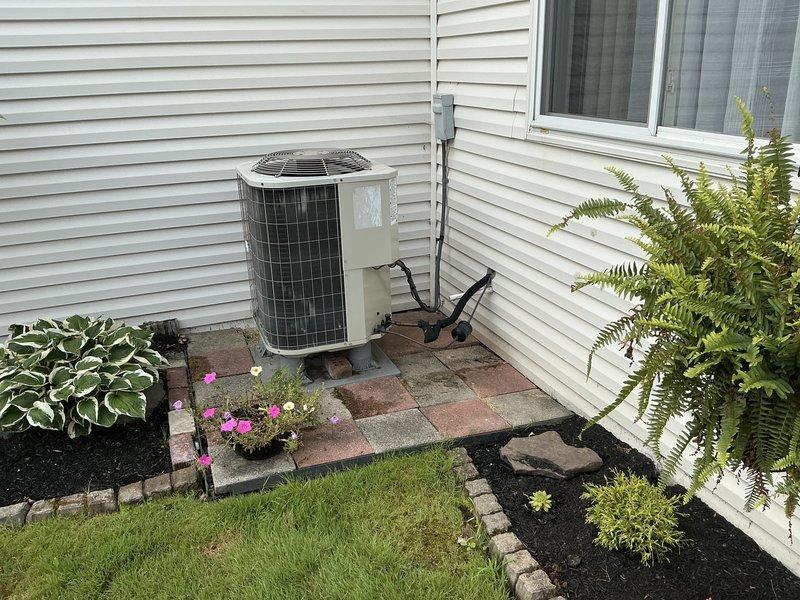 Provided estimate for complete heat pump system replacement on 10-year-old unit with confirmed refrigerant leak. Evaluated existing Carrier indoor air handler and outdoor heat pump unit, documented current installation configuration including ductwork connections and electrical service, and presented replacement options to customer.