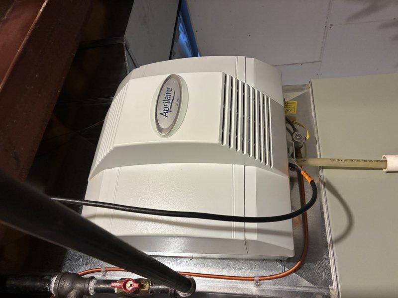 Completed MVP cooling maintenance visit on residential HVAC system. Performed comprehensive inspection of cooling equipment including blower assembly and humidifier unit. Documented system components with photos showing Aprilaire humidifier with connected water supply line and electrical connections in proper working condition, and blower wheel assembly showing normal operational wear with dust accumulation on blades. All equipment functioning as designed with no immediate service needs identified.